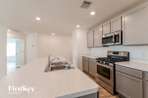 A kitchen with a stainless steel sink and oven.