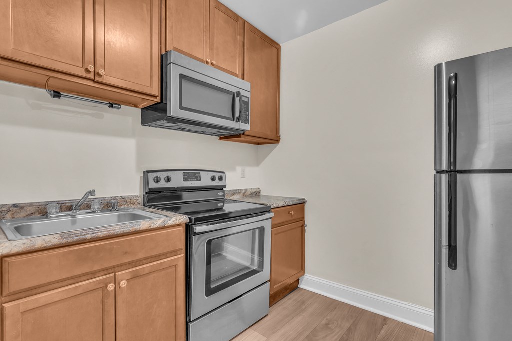 a kitchen with stainless steel appliances and wooden cabinets