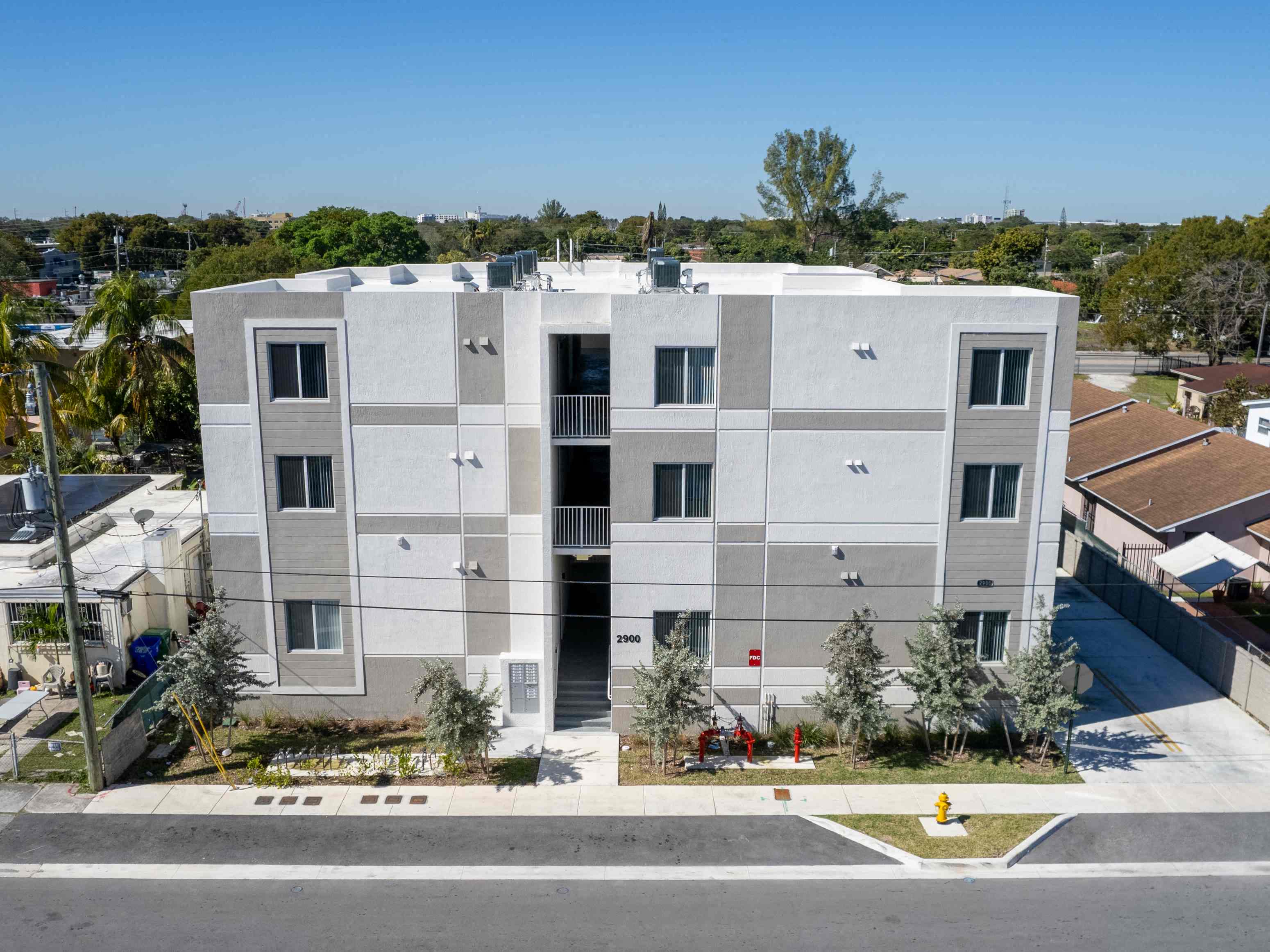 an aerial view of a white building with balconies