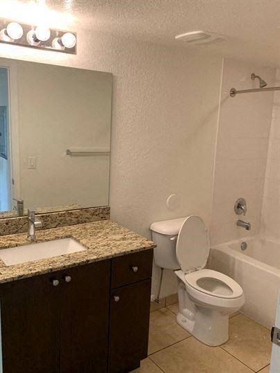 a bathroom with a toilet and a sink and a shower
