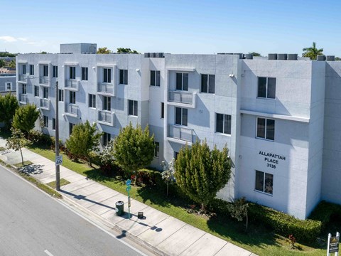 an aerial view of an apartment building on a city street