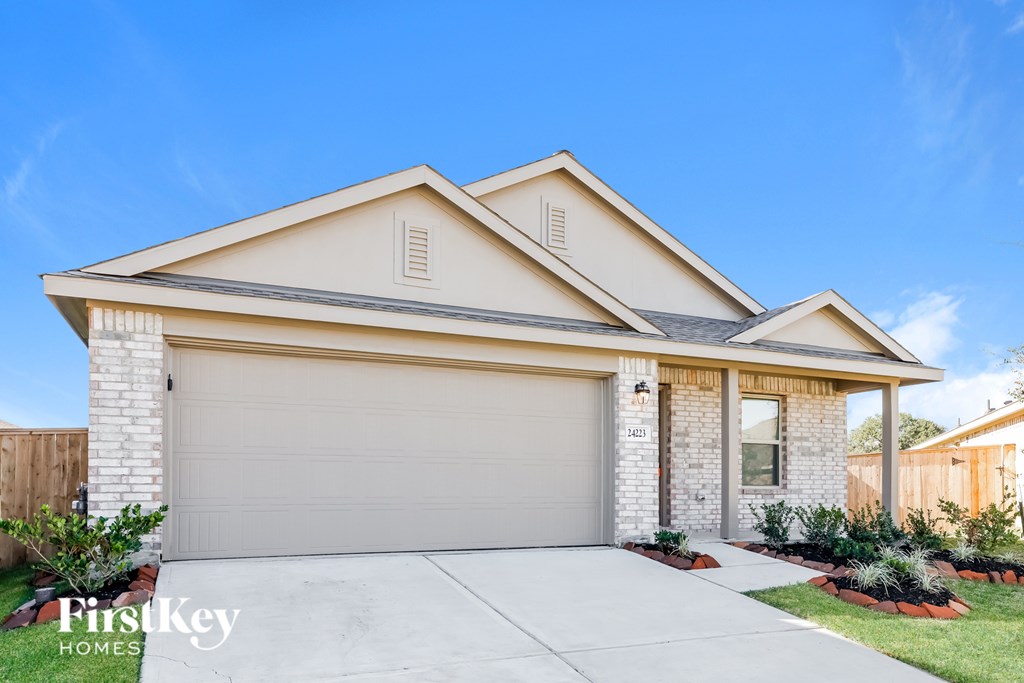A two-story house with a garage is for sale.