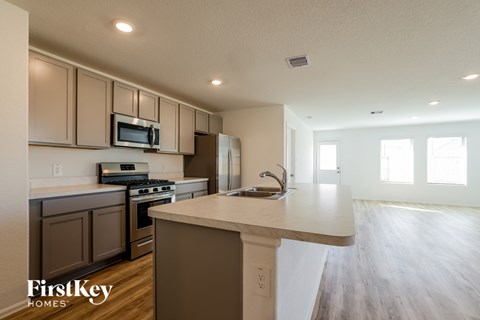 A kitchen with brown cabinets and a white island.