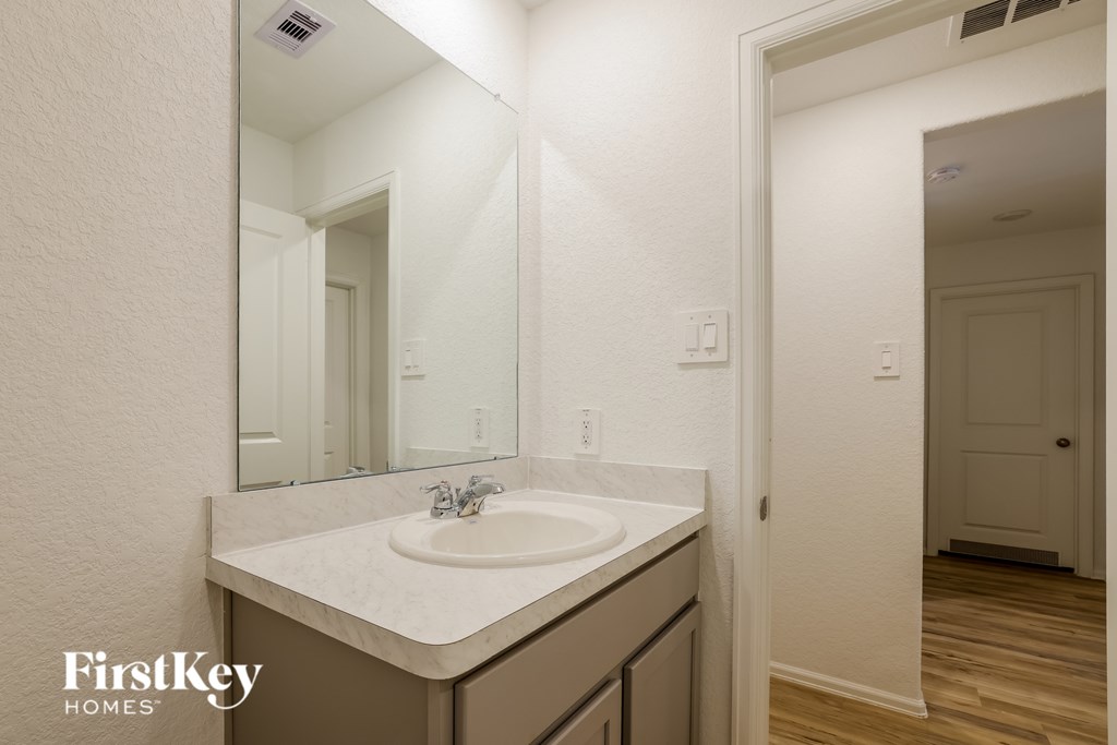 A bathroom sink with a mirror above it.