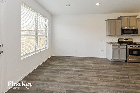 A kitchen with a stove top oven and microwave.