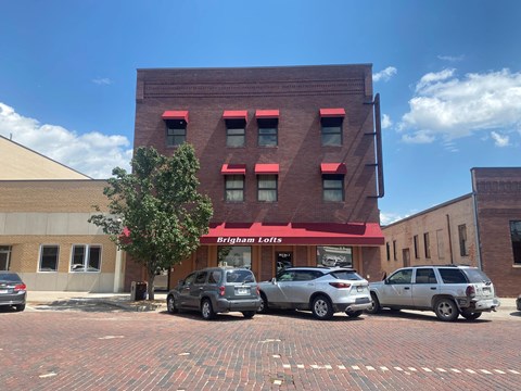 a red building with three cars parked in front of it