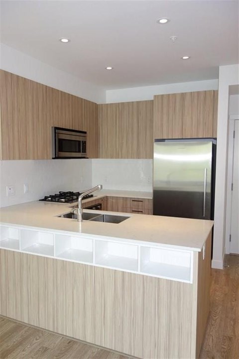 A kitchen with a stove top oven and a microwave.