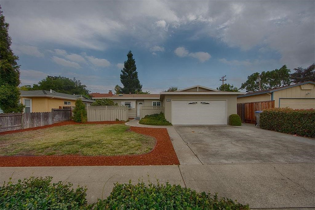 a house with a driveway and a white garage door