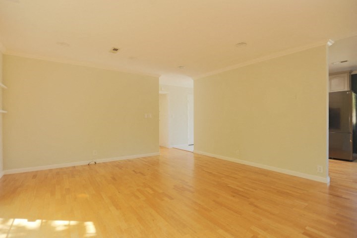 an empty living room with a hard wood floor