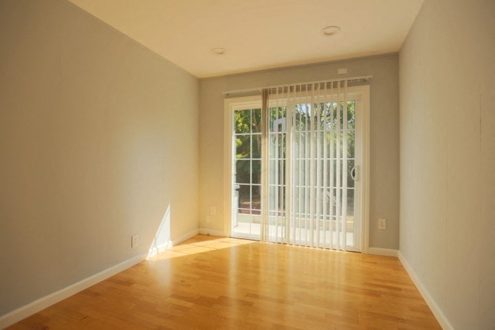 a empty living room with a sliding glass door