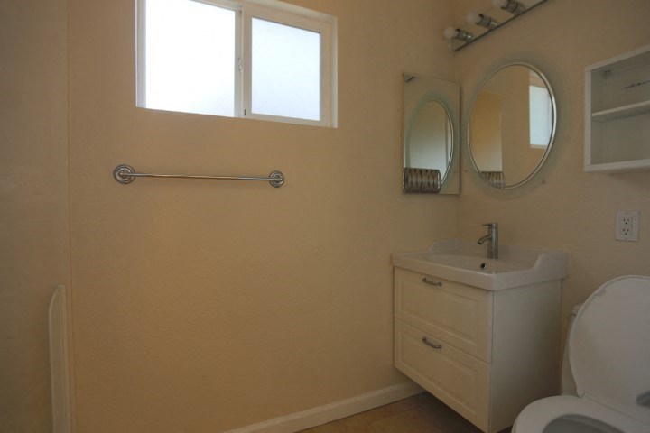 a bathroom with a sink toilet and a mirror