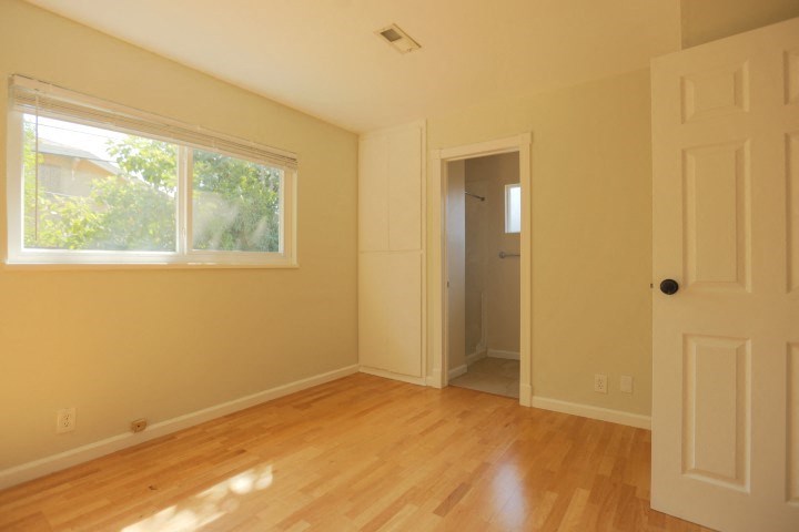 an empty room with a door and a window