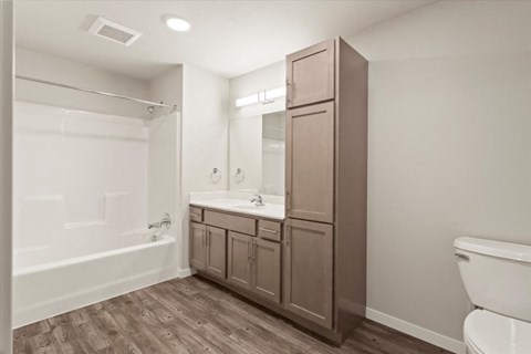 a bathroom with a toilet and a sink and a shower