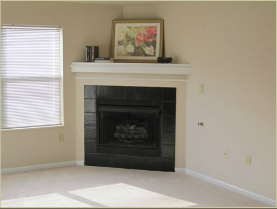 a living room with a fireplace and a window