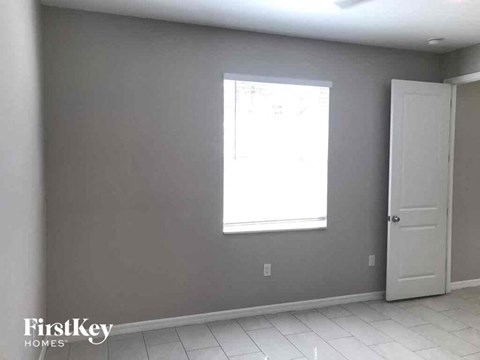 an empty room with a window and a door