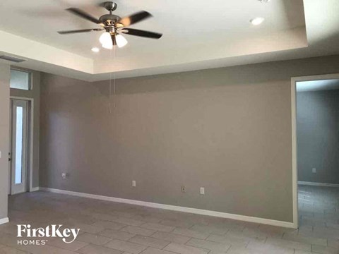 a empty living room with a ceiling fan