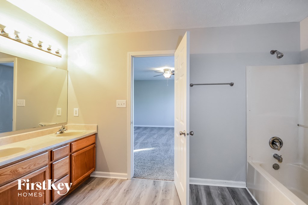 a bathroom with a sink and a mirror and a shower