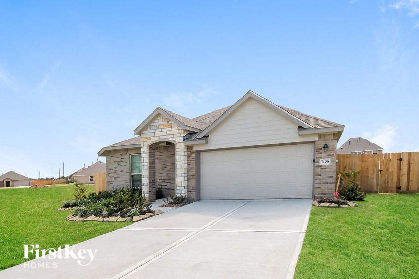 a home with a sidewalk in front of a lawn
