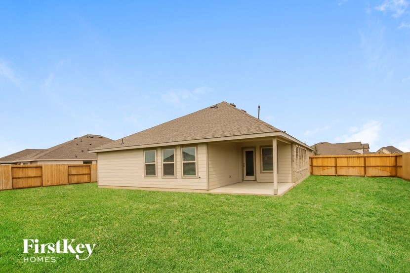 a small house with a yard and a fence