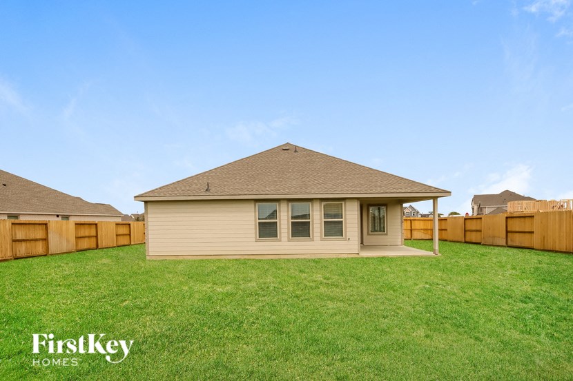 a small house in a backyard with a fence