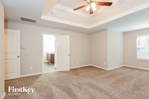 the master bedroom is spacious and has a ceiling fan