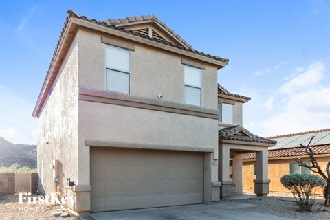 a house with a garage door in front of it