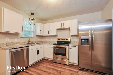 a kitchen with stainless steel appliances and white cabinets