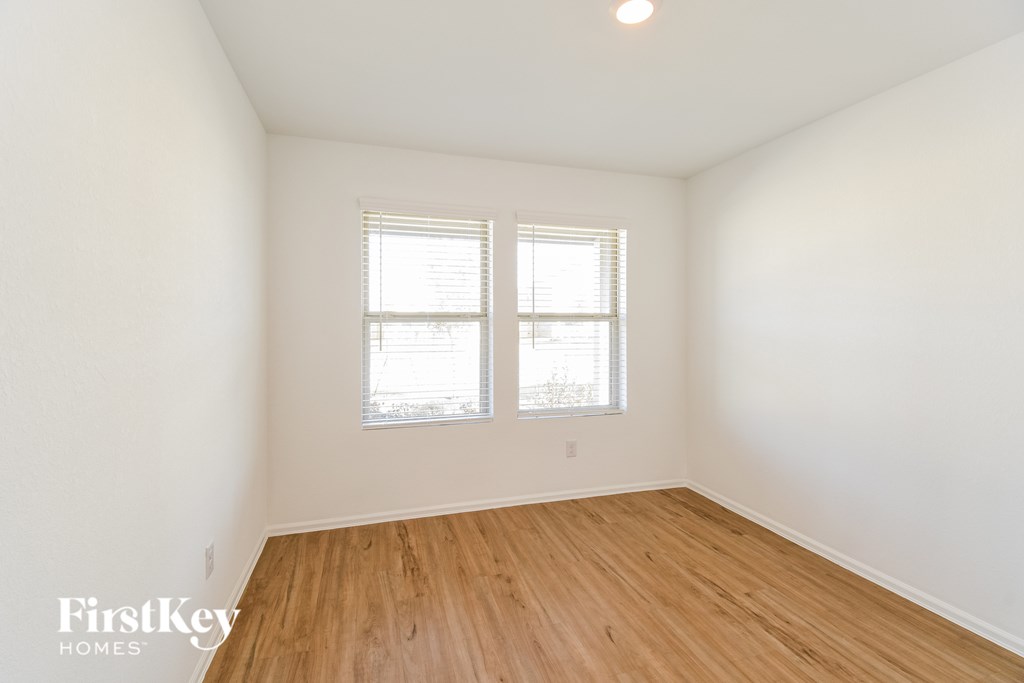 A room with wooden floors and a window.