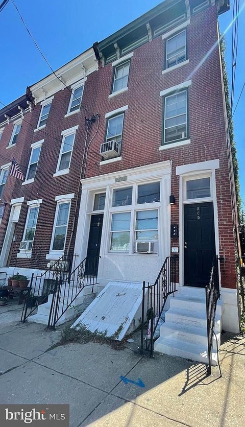 a brick building with stairs in front of it