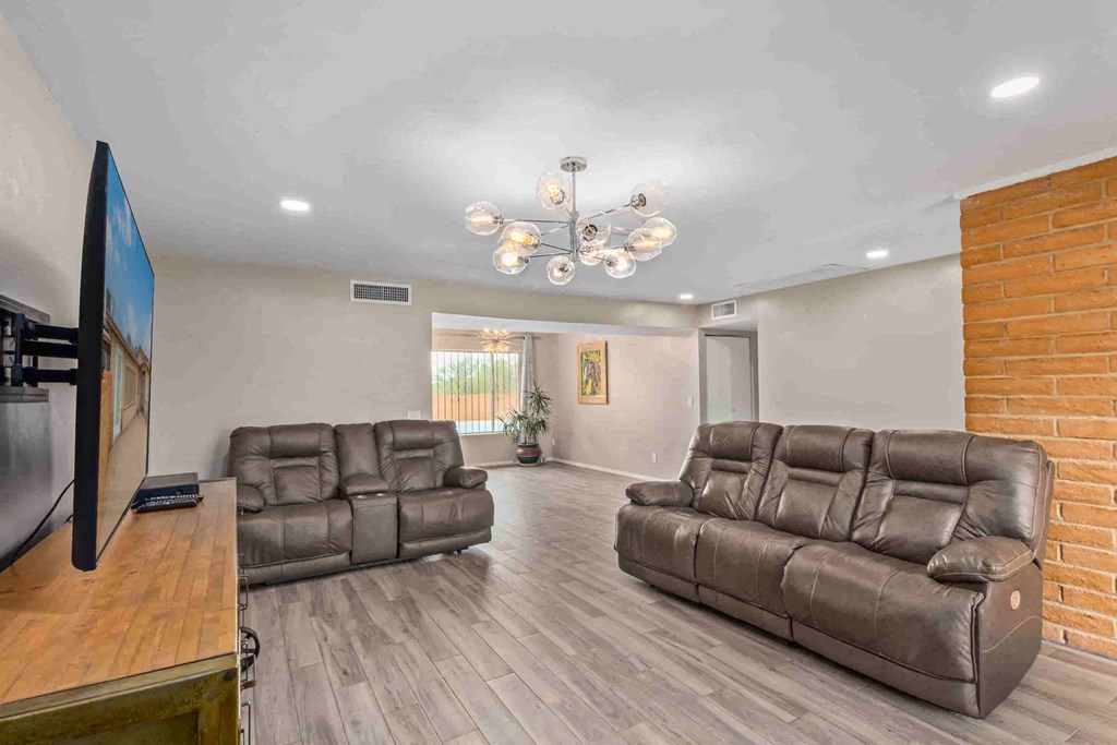 a living room filled with couches and a tv
