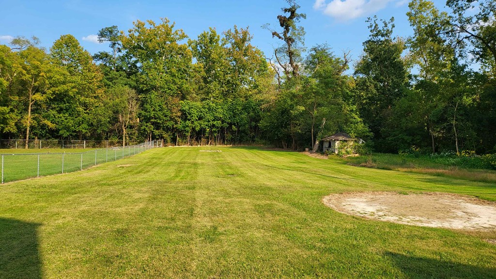 a baseball field with a gazebo in the middle of a grass field
