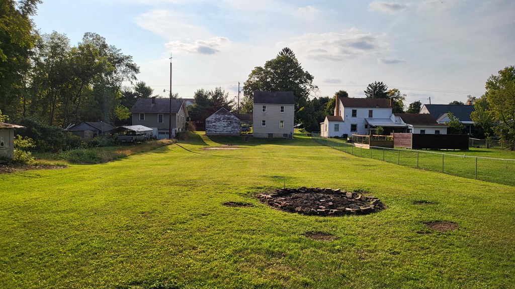 a green field with houses in the background