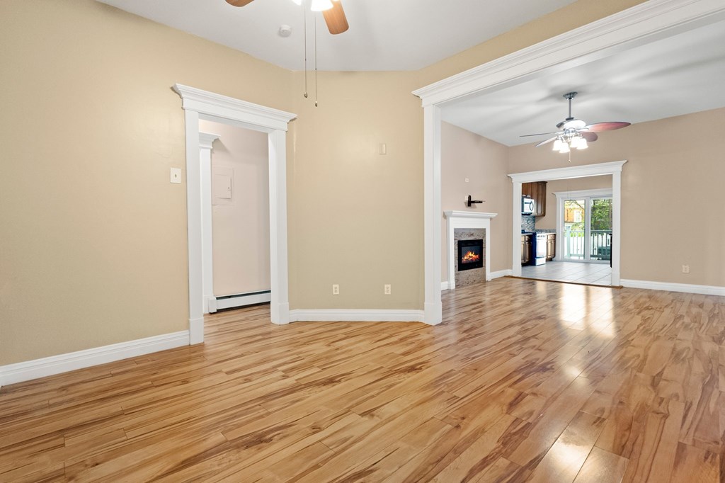 A room with wooden floors and a ceiling fan.