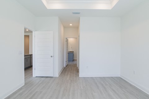 A white room with a doorway leading to another room.