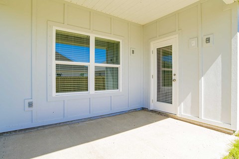 A white house with a door and window.