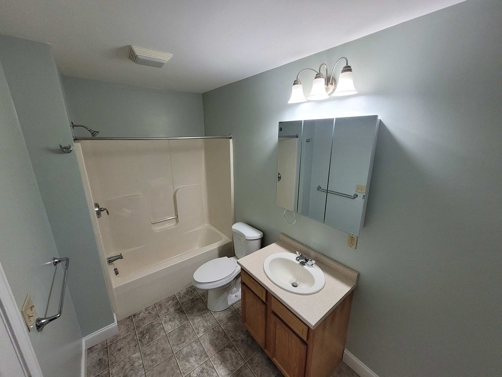a bathroom with a sink toilet and a shower