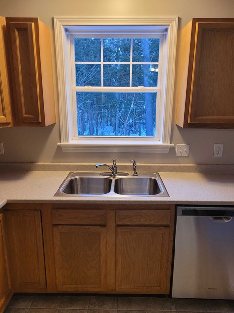 a kitchen with a sink and a window