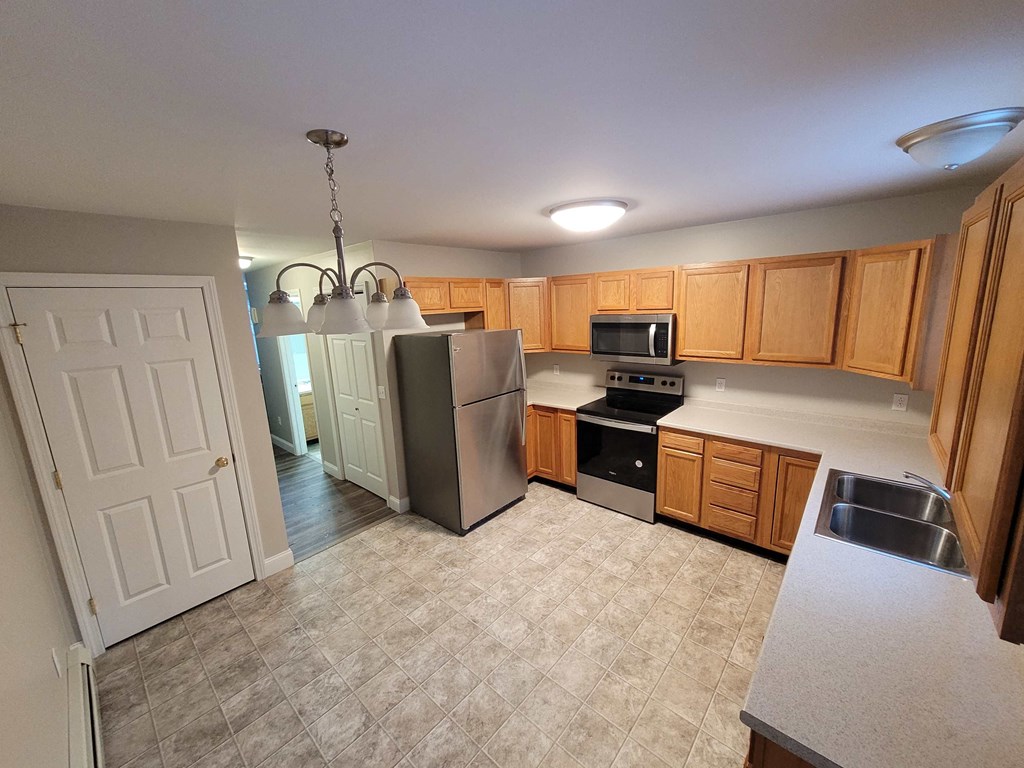 a kitchen with stainless steel appliances and wooden cabinets