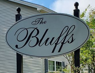 the bluffs sign in front of a house