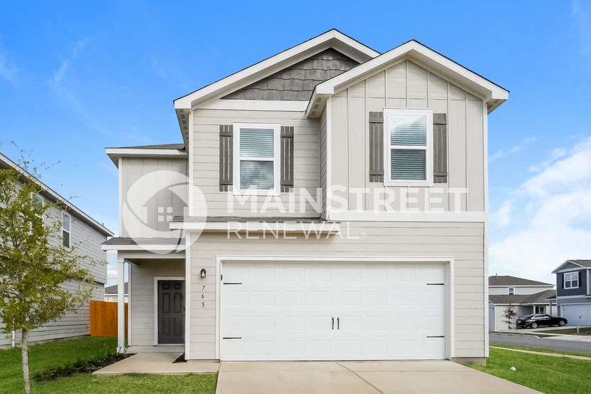 a house with a white garage door and a lawn
