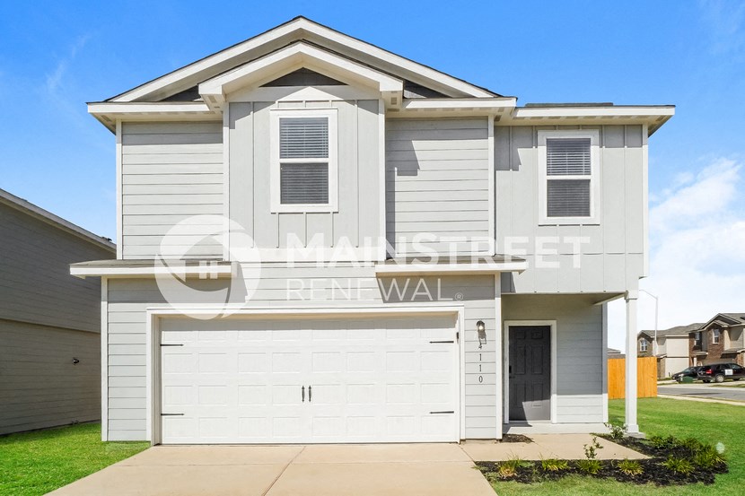a white house with a white garage door