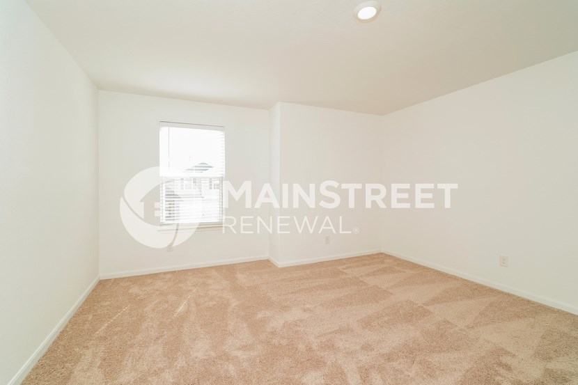 a room with a carpeted floor and a window