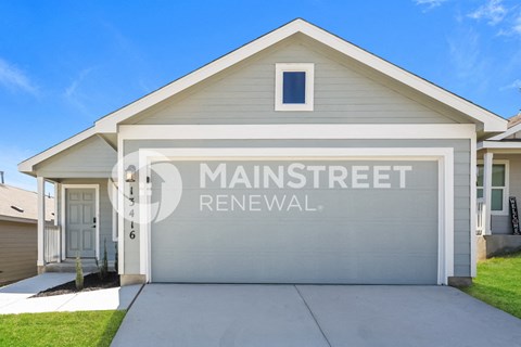 a single story home with a garage door on the side of it