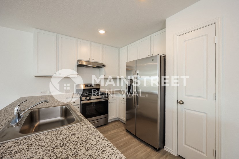 a kitchen with granite counter tops and stainless steel appliances