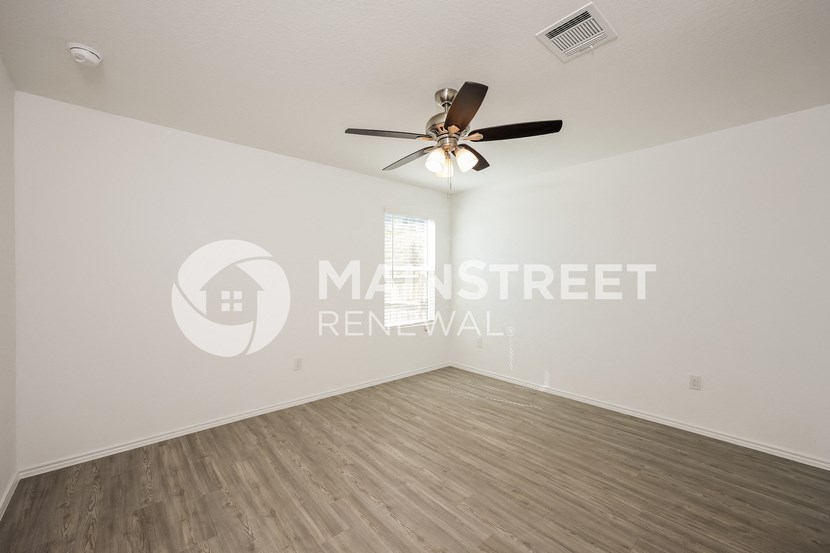 large living room with a ceiling fan