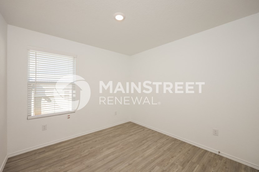 renovated living room with hardwood flooring and window