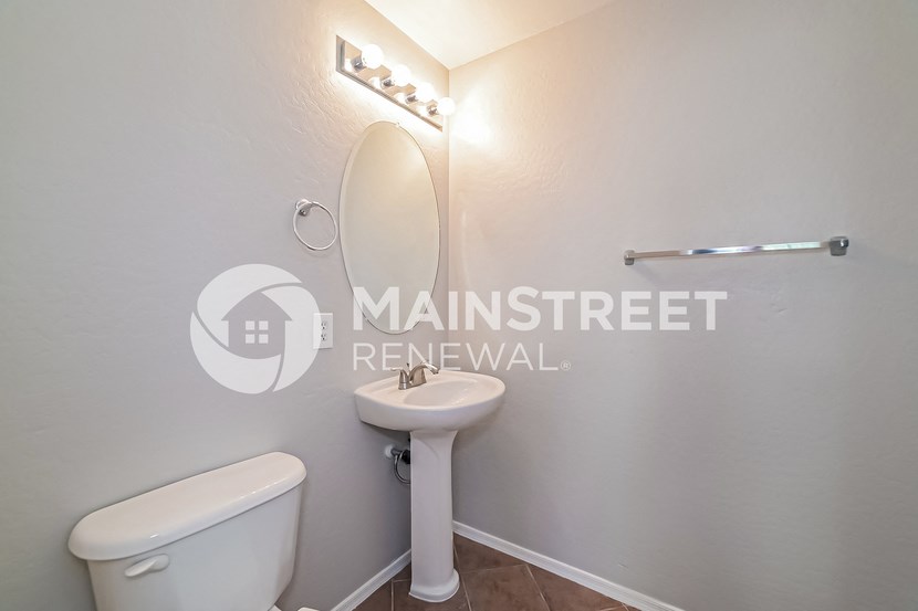 renovated bathroom for a rental property with a toilet and sink