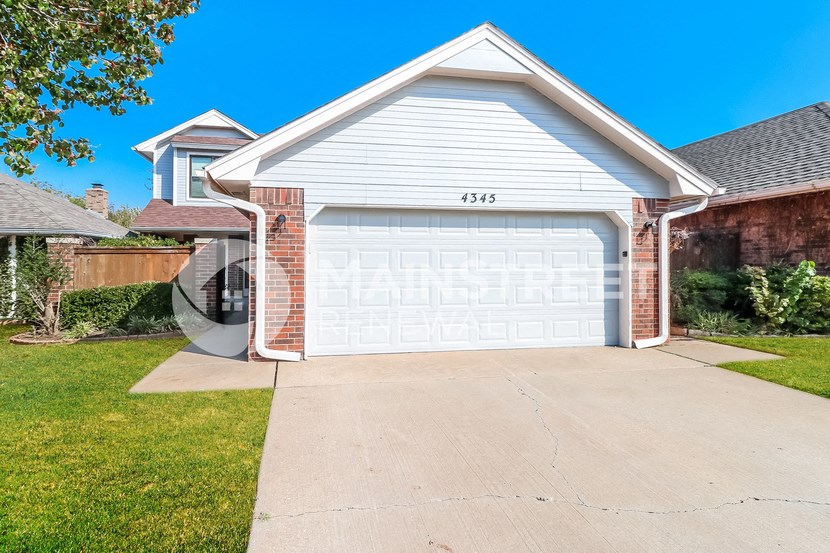 a white garage door in front of a house