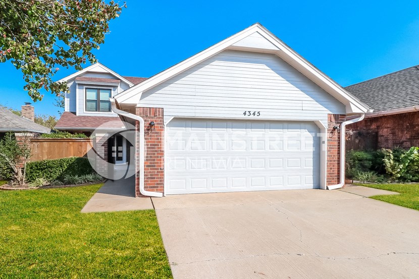 a white garage door in front of a house