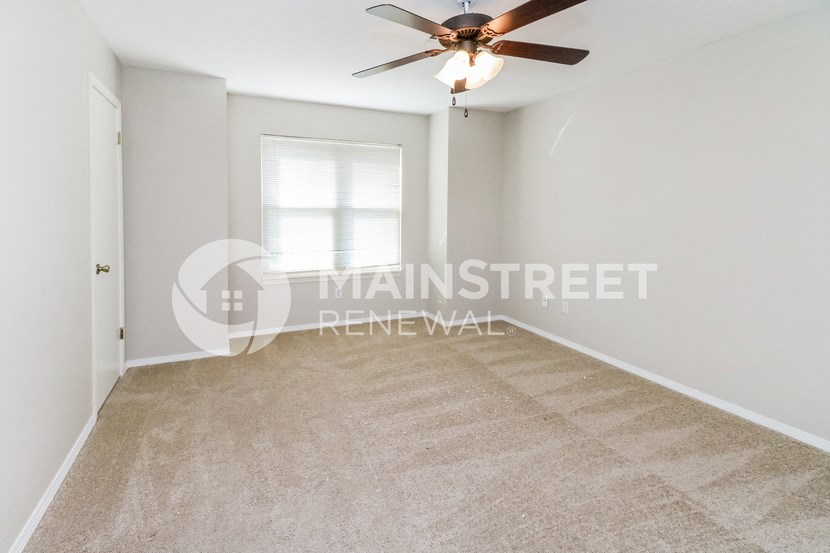 a bedroom apartment with a closet and a ceiling fan